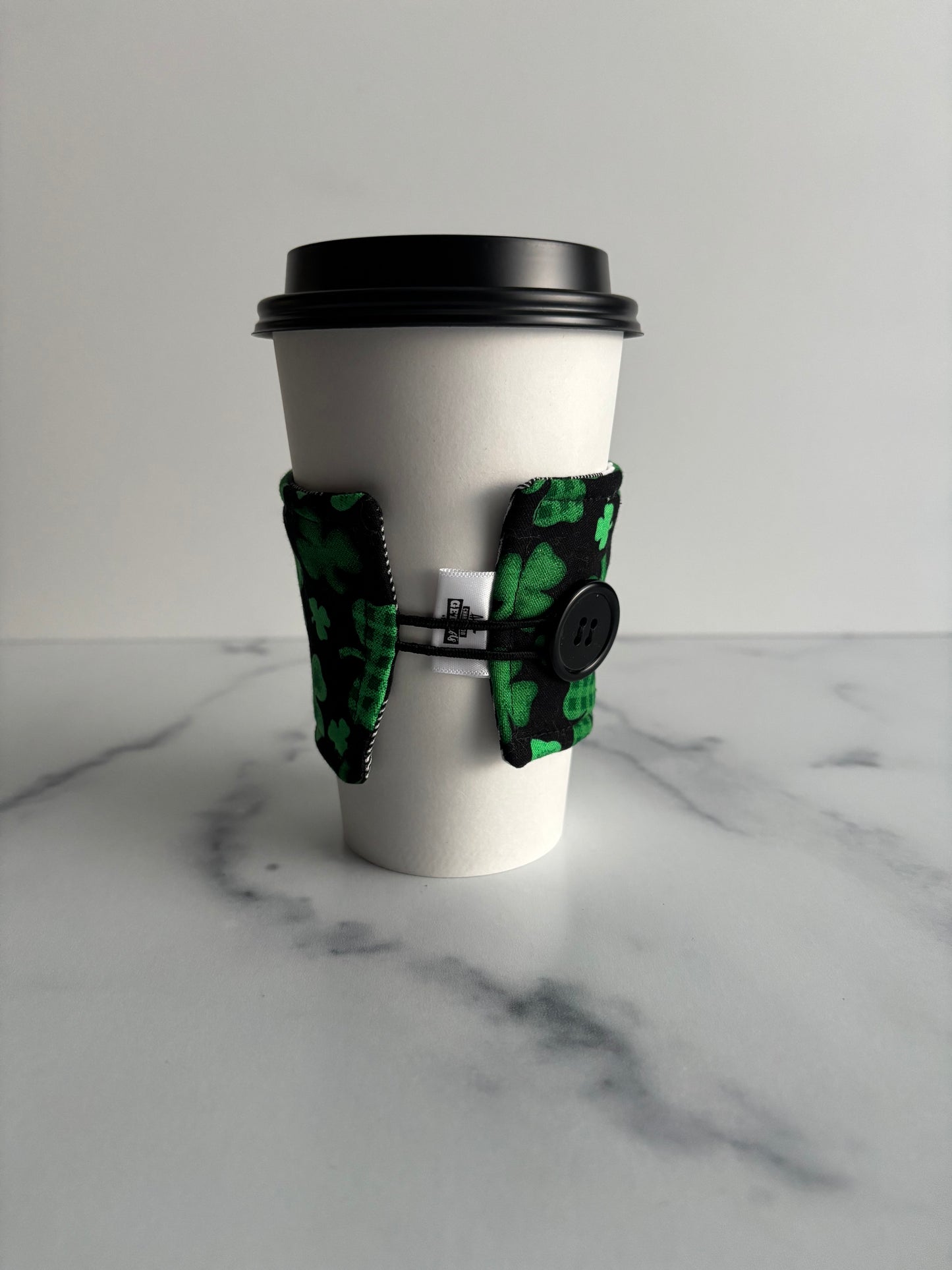 Clovers on Black - Reusable Coffee Sleeve