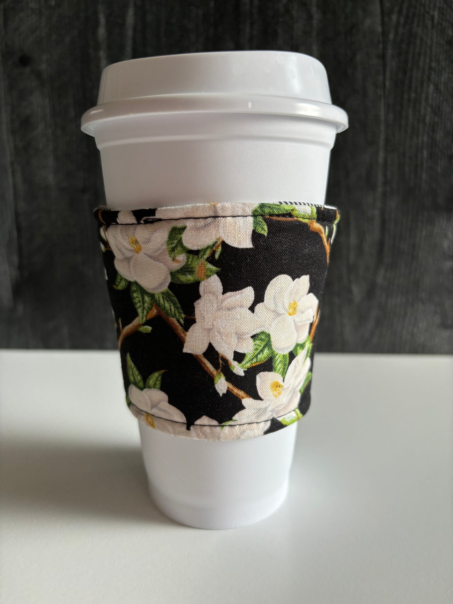 Magnolias on Black - Reusable Coffee Sleeve