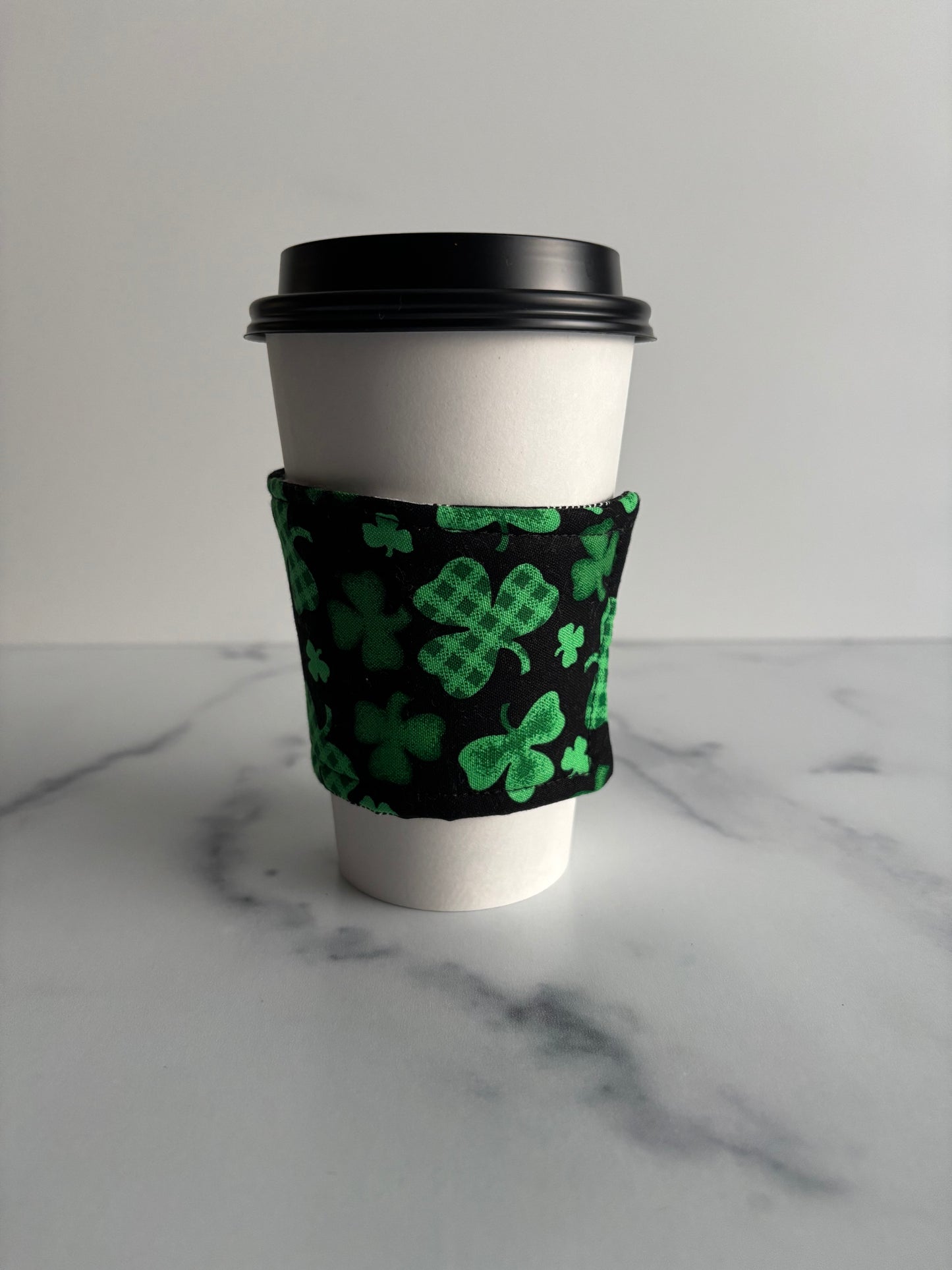 Clovers on Black - Reusable Coffee Sleeve